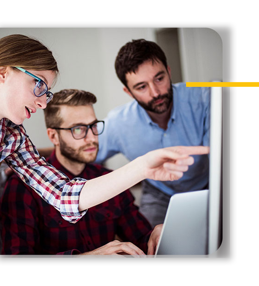 3 people studying a print monitor